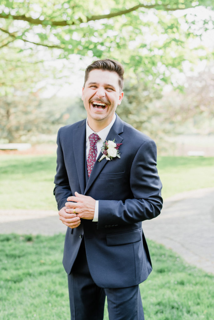 Groom in navy blue three piece suit by Jenn Kavanagh Photography