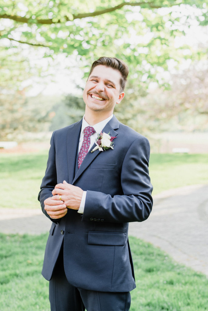 Groom in navy blue three piece suit by Jenn Kavanagh Photography
